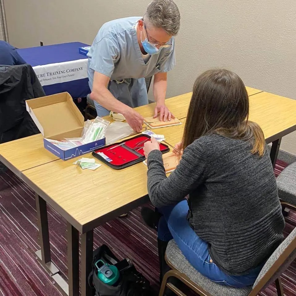 students suturing with a plus medics suture practice kit