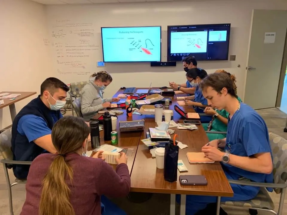students suturing with a plus medics suture practice kit