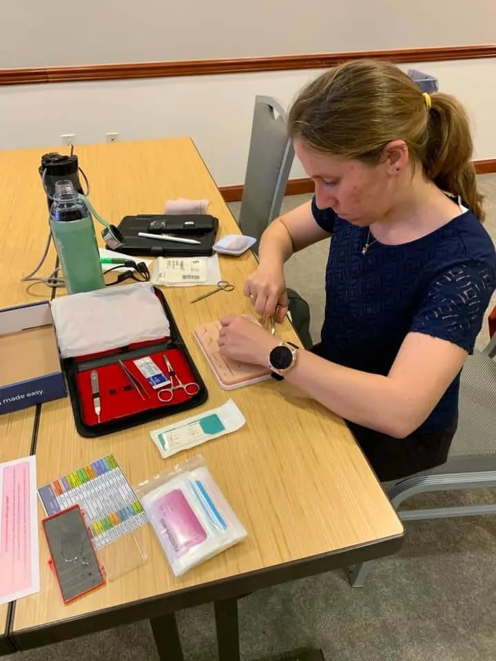 students suturing with a plus medics suture practice kit