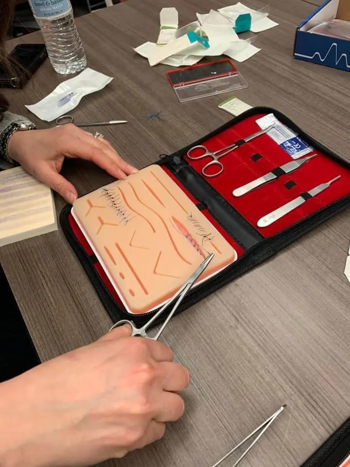 students suturing with a plus medics suture practice kit